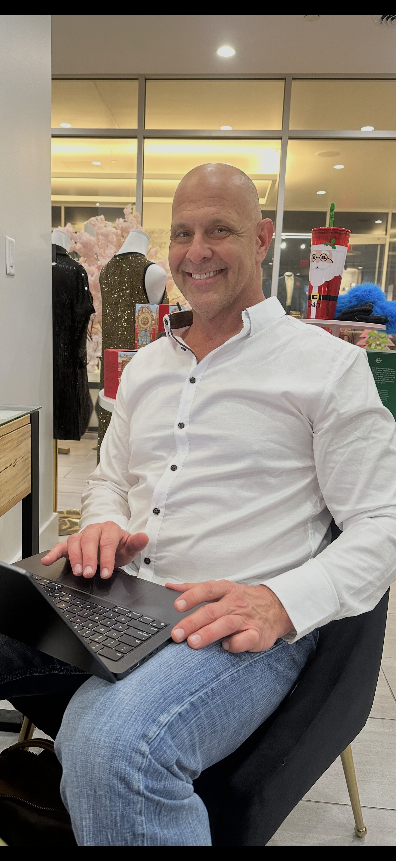 mikeormichaellarose-1 — Michael LaRose smiling at a desk with a laptop